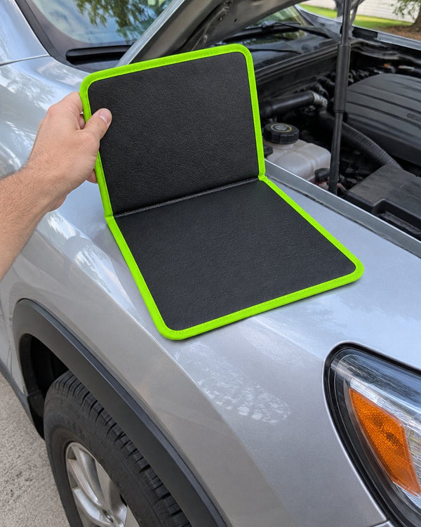 Opening the folding magnetic mat on a car fender